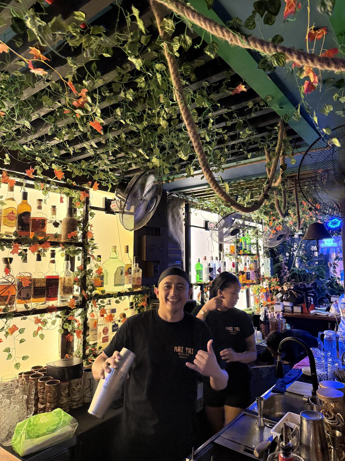 Mai Tai Boracay bartender mixing a cocktail behind the tiki bar